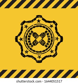 crossed bandage plaster icon grunge black emblem with yellow background, warning sign. Vector Illustration. Detailed.