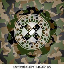crossed bandage plaster icon inside camo texture