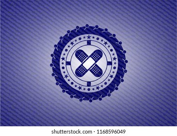 crossed bandage plaster icon inside emblem with jean high quality background