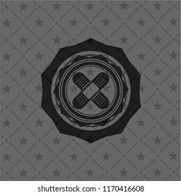 crossed bandage plaster icon inside dark emblem