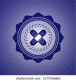 crossed bandage plaster icon inside badge with jean texture