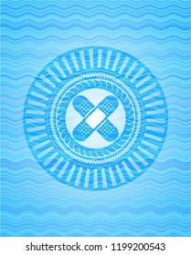 crossed bandage plaster icon inside sky blue water wave badge.