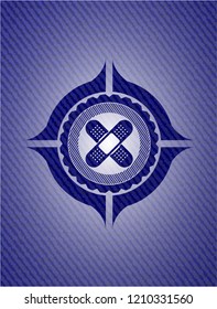 crossed bandage plaster icon inside emblem with jean background