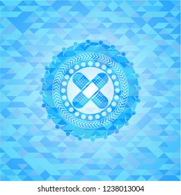 crossed bandage plaster icon inside realistic light blue emblem. Mosaic background
