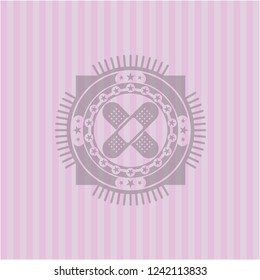 crossed bandage plaster icon inside realistic pink emblem