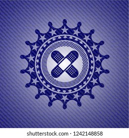 crossed bandage plaster icon inside emblem with jean texture