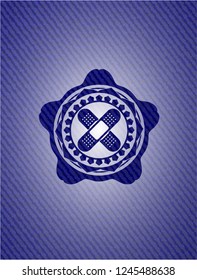 crossed bandage plaster icon inside emblem with denim high quality background