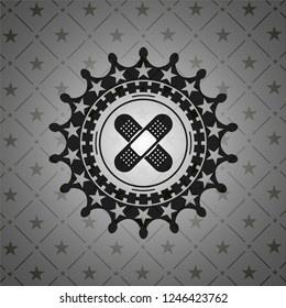 crossed bandage plaster icon inside black badge