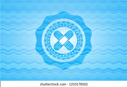 crossed bandage plaster icon inside sky blue water badge background.