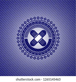 crossed bandage plaster icon inside denim background