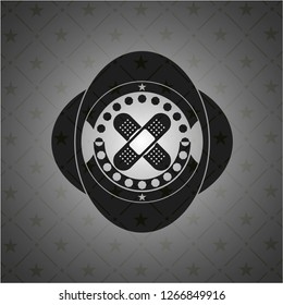 crossed bandage plaster icon inside realistic black emblem