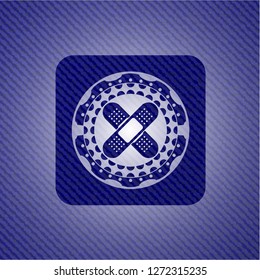 crossed bandage plaster icon inside emblem with jean background