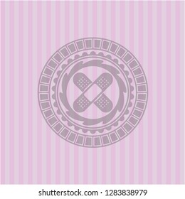 crossed bandage plaster icon inside pink emblem. Vintage.