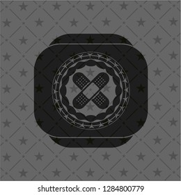 crossed bandage plaster icon inside dark emblem