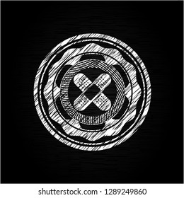 crossed bandage plaster icon inside chalkboard emblem written on a blackboard