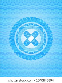 crossed bandage plaster icon inside water wave emblem.