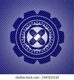 crossed bandage plaster icon inside emblem with jean high quality background