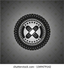 crossed bandage plaster icon inside realistic black emblem