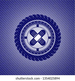 crossed bandage plaster icon inside emblem with denim high quality background