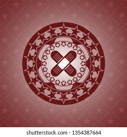 crossed bandage plaster icon inside red icon or emblem