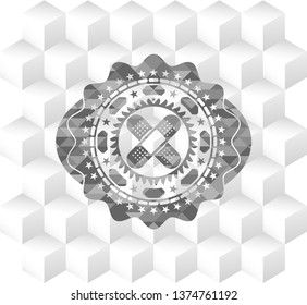 crossed bandage plaster icon inside grey emblem with cube white background