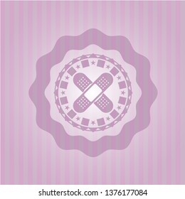 crossed bandage plaster icon inside pink emblem