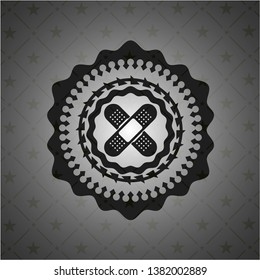 crossed bandage plaster icon inside dark badge or emblem