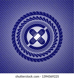 crossed bandage plaster icon inside emblem with denim high quality background