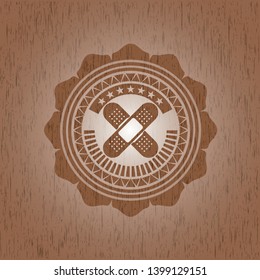 crossed bandage plaster icon inside retro wooden emblem