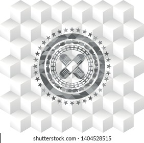 crossed bandage plaster icon inside retro style grey emblem with geometric cube white background