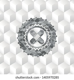crossed bandage plaster icon inside grey emblem with geometric cube white background