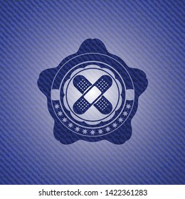 crossed bandage plaster icon inside emblem with jean background