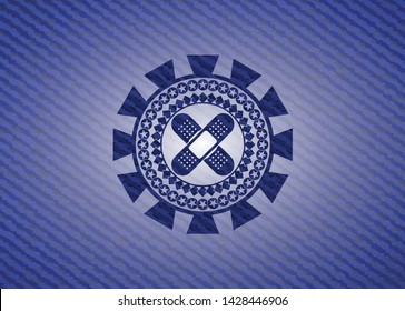 crossed bandage plaster icon inside emblem with jean texture