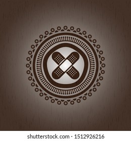crossed bandage plaster icon inside wood emblem. Retro
