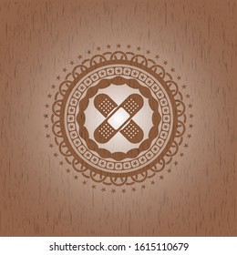 crossed bandage plaster icon inside wooden emblem