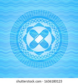 crossed bandage plaster icon inside sky blue water wave style emblem.