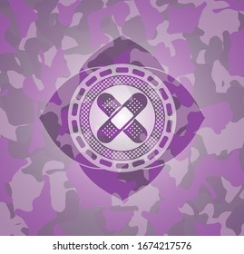 crossed bandage plaster icon inside pink and purple camo emblem