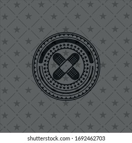 crossed bandage plaster icon inside dark badge or emblem