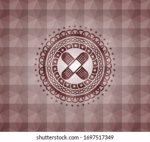 crossed bandage plaster icon inside red seamless badge with geometric pattern background.