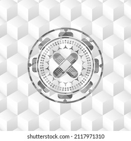 icono de escayola de vendas cruzada dentro de la placa gris con fondo blanco cubo geométrico. 