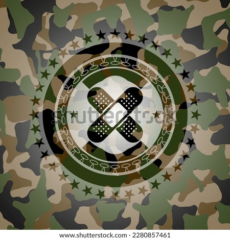 crossed bandage plaster icon on camo texture. 