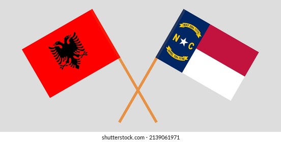 Crossed flags of Albania and The State of North Carolina. Official colors. Correct proportion. Vector illustration
