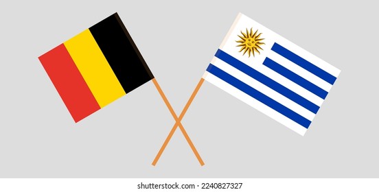 Crossed flags of Belgium and Uruguay. Official colors. Correct proportion. Vector illustration
