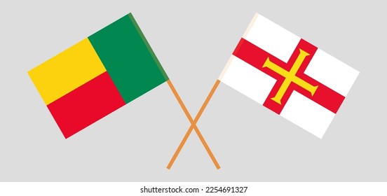 Crossed flags of Benin and Bailiwick of Guernsey. Official colors. Correct proportion. Vector illustration
