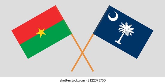 Überquerte Flaggen von Burkina Faso und dem Staat South Carolina. Offizielle Farben. Richtiger Anteil. Vektorgrafik
