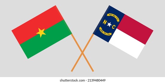 Überquerte Flaggen von Burkina Faso und dem Staat North Carolina. Offizielle Farben. Richtiger Anteil. Vektorgrafik
