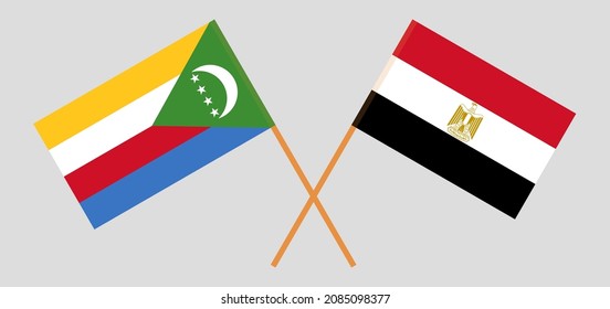 Banderas cruzadas de las Comoras y Egipto. Colores oficiales. Proporción correcta. Ilustración del vector
