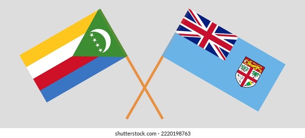 Crossed flags of the Comoros and Fiji. Official colors. Correct proportion. Vector illustration
