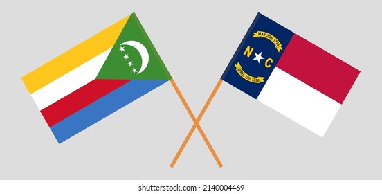 Crossed flags of the Comoros and The State of North Carolina. Official colors. Correct proportion. Vector illustration
