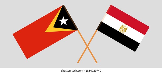 Banderas cruzadas de Timor Oriental y Egipto. Colores oficiales. Proporción correcta. Ilustración del vector
